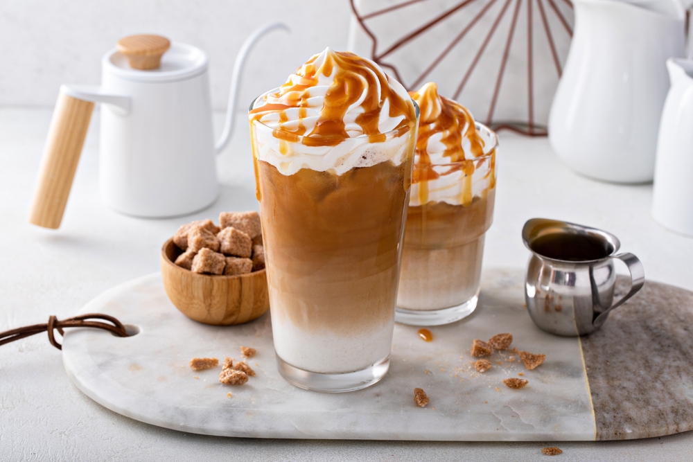 Iced,Caramel,Latte,Topped,With,Whipped,Cream,And,Caramel,Sauce,